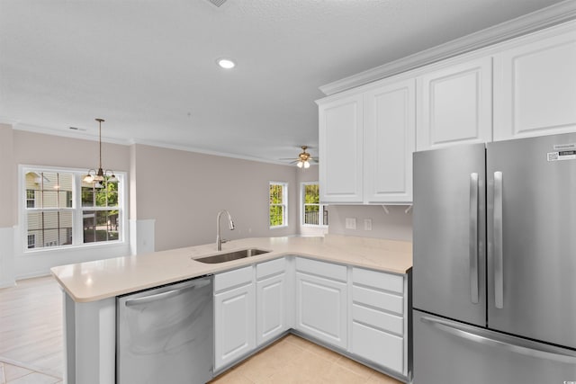 5870 Longwood Dr Unit 201, Murrells Inlet, SC 29576 - kitchen with stainless steel appliances, a peninsula, light countertops, white cabinets, and crown molding