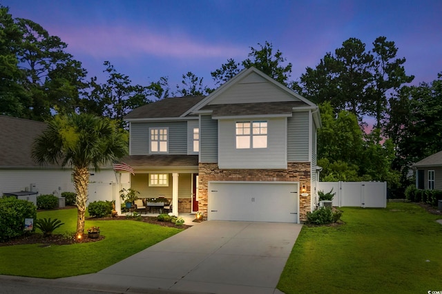 1007 Oak Marsh Ln, North Myrtle Beach, SC 29582 - craftsman-style home featuring concrete driveway, stone siding, a garage, a porch, and a gate
