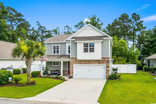 1007 Oak Marsh Ln, North Myrtle Beach, SC 29582 - craftsman-style home featuring driveway, an attached garage, stone siding, a porch, and a gate