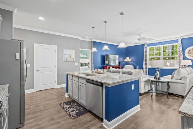 1007 Oak Marsh Ln, North Myrtle Beach, SC 29582 - kitchen featuring appliances with stainless steel finishes, open floor plan, a ceiling fan, light wood-style flooring, and ornamental molding