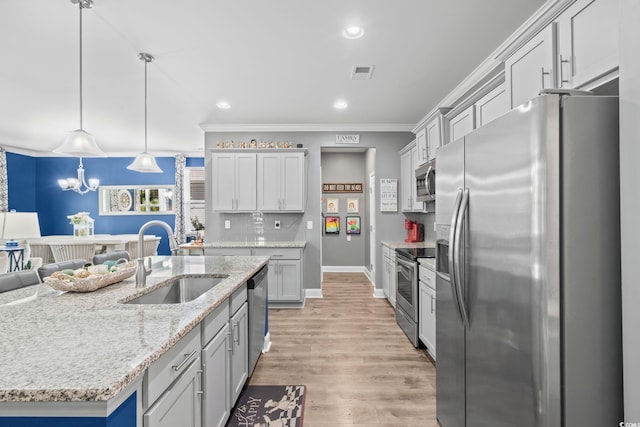 1007 Oak Marsh Ln, North Myrtle Beach, SC 29582 - kitchen with stainless steel appliances, tasteful backsplash, recessed lighting, ornamental molding, and light stone countertops