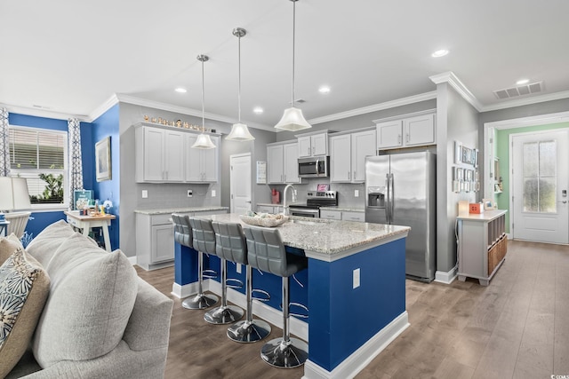 1007 Oak Marsh Ln, North Myrtle Beach, SC 29582 - kitchen with stainless steel appliances, plenty of natural light, tasteful backsplash, ornamental molding, and an island with sink