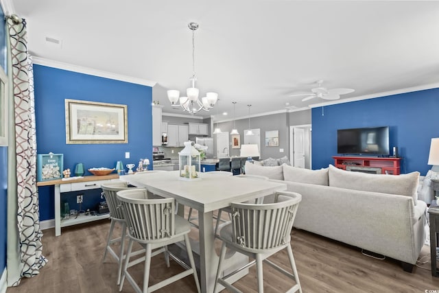 1007 Oak Marsh Ln, North Myrtle Beach, SC 29582 - dining area featuring ornamental molding, a ceiling fan, dark wood finished floors, and a chandelier