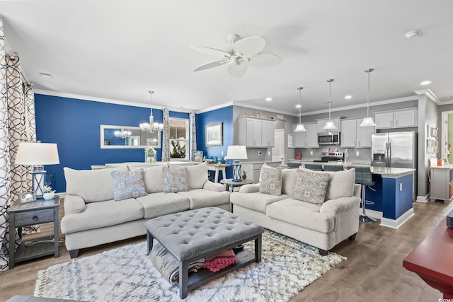 1007 Oak Marsh Ln, North Myrtle Beach, SC 29582 - living room with recessed lighting, a chandelier, ceiling fan, wood finished floors, and crown molding