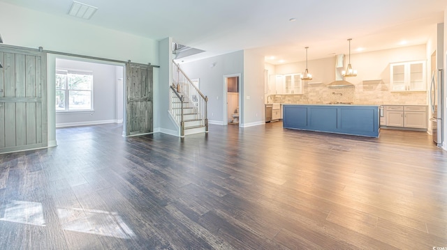 520 Oak Pond Ct, Conway, SC 29526 - unfurnished living room with a barn door, dark wood-style floors, and stairway
