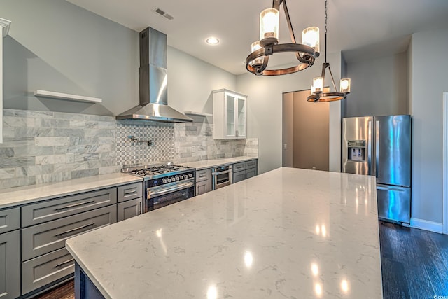 520 Oak Pond Ct, Conway, SC 29526 - kitchen featuring stainless steel appliances, wall chimney range hood, a chandelier, and light stone countertops