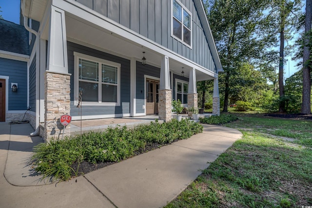 520 Oak Pond Ct, Conway, SC 29526 - doorway to property with board and batten siding, stone siding, and covered porch