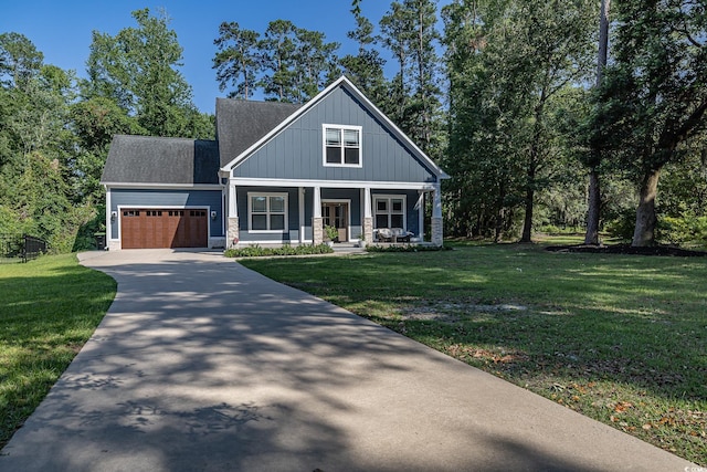520 Oak Pond Ct, Conway, SC 29526 - view of front facade with an attached garage, concrete driveway, a porch, a front yard, and roof with shingles