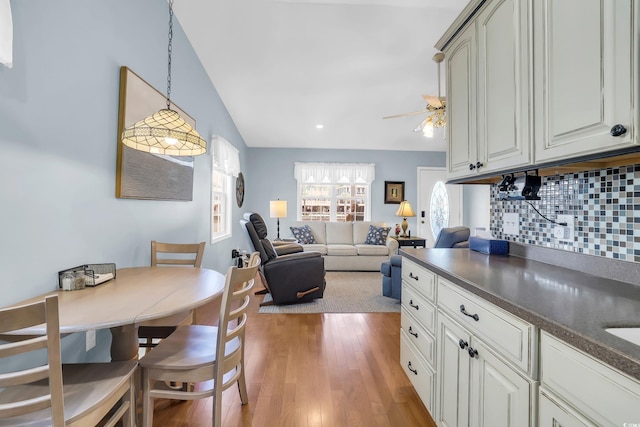 6001-Q21 S Kings Hwy, Myrtle Beach, SC 29575 - kitchen featuring backsplash, dark countertops, light wood-style floors, ceiling fan, and hanging light fixtures