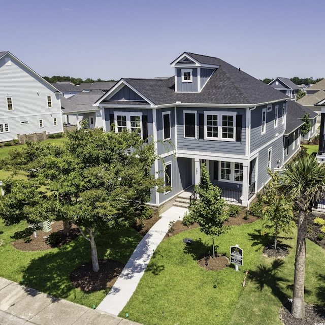 287 W Palms Dr, Myrtle Beach, SC 29579 - view of front of property featuring a shingled roof, a porch, and a front yard