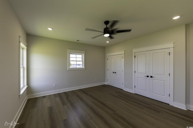 287 W Palms Dr, Myrtle Beach, SC 29579 - unfurnished bedroom with two closets, dark wood-style flooring, recessed lighting, and a ceiling fan