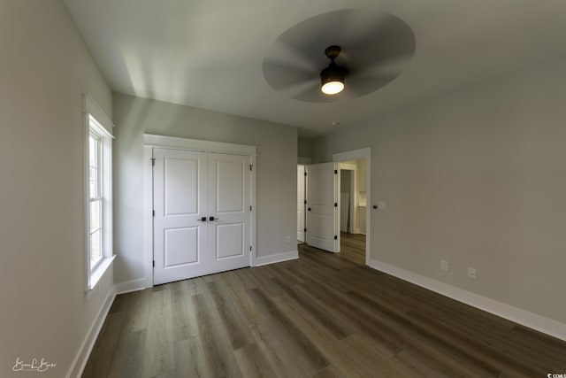 287 W Palms Dr, Myrtle Beach, SC 29579 - unfurnished bedroom with wood finished floors, multiple windows, a closet, and ceiling fan