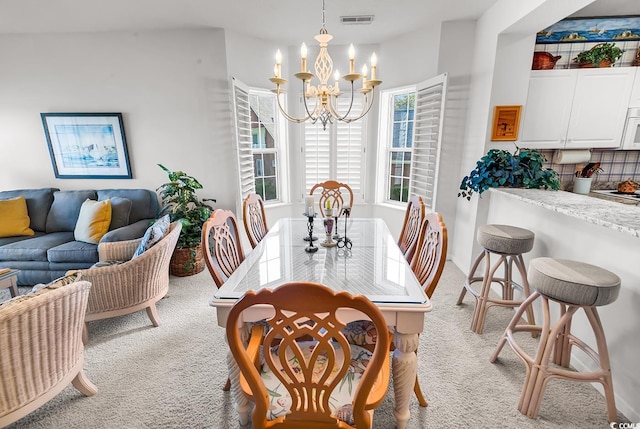 4400 Turtle Ln Unit 2-D, Little River, SC 29566 - dining area with light colored carpet and a chandelier