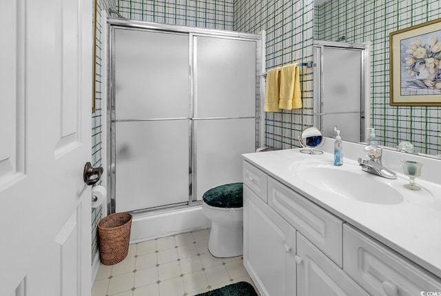 4400 Turtle Ln Unit 2-D, Little River, SC 29566 - bathroom with wallpapered walls, vanity, and a stall shower