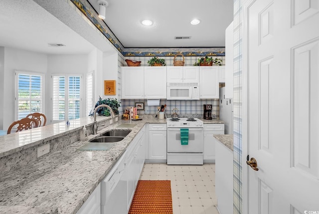 4400 Turtle Ln Unit 2-D, Little River, SC 29566 - kitchen with white appliances, light floors, white cabinets, light stone counters, and recessed lighting