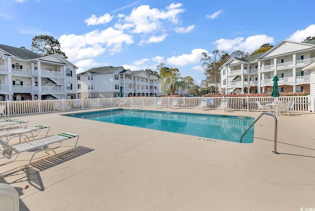 4400 Turtle Ln Unit 2-D, Little River, SC 29566 - community pool featuring a residential view and a patio