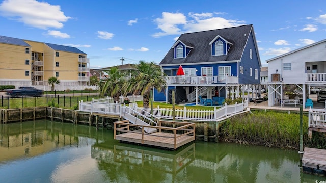 302 46th Ave N, North Myrtle Beach, SC 29582 - dock with stairs, a fenced backyard, and a deck with water view