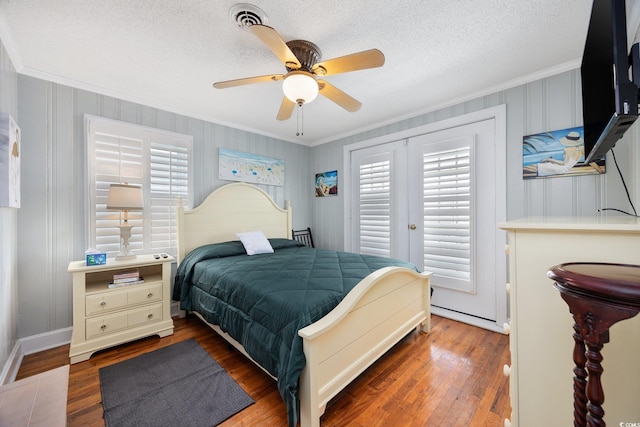 302 46th Ave N, North Myrtle Beach, SC 29582 - bedroom featuring crown molding, multiple windows, wood finished floors, a textured ceiling, and a ceiling fan
