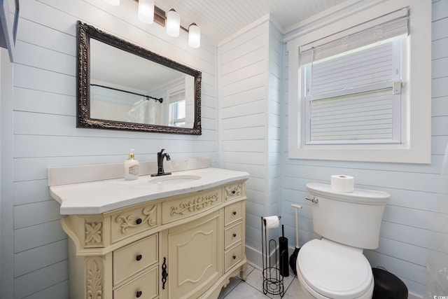 302 46th Ave N, North Myrtle Beach, SC 29582 - bathroom featuring vanity, wooden walls, and ornamental molding