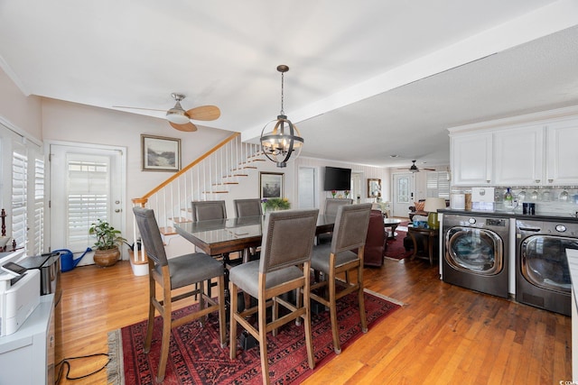 302 46th Ave N, North Myrtle Beach, SC 29582 - dining room with ceiling fan, light wood-style flooring, separate washer and dryer, a chandelier, and stairs