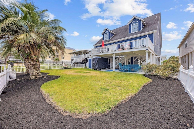 302 46th Ave N, North Myrtle Beach, SC 29582 - rear view of house featuring a patio area, a fenced backyard, stairway, a wooden deck, and roof with shingles