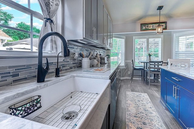 2479 Burning Tree Ln, Little River, SC 29566 - kitchen with blue cabinets, tasteful backsplash, wood finished floors, decorative light fixtures, and vaulted ceiling