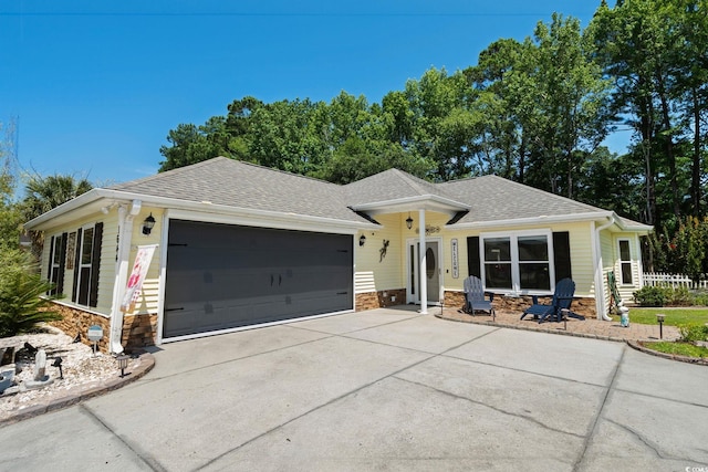 1644 Langley Dr, Longs, SC 29568 - view of front of house featuring stone siding, an attached garage, roof with shingles, and driveway