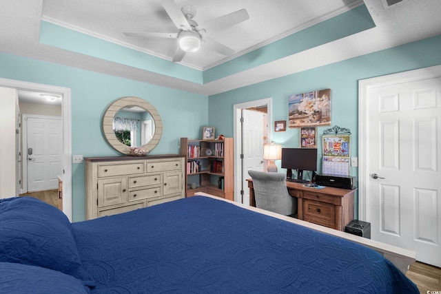 1644 Langley Dr, Longs, SC 29568 - bedroom with crown molding, wood finished floors, a tray ceiling, a ceiling fan, and a desk