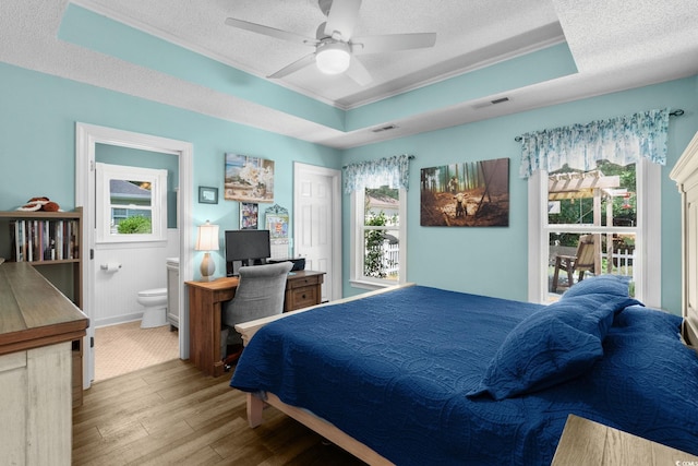 1644 Langley Dr, Longs, SC 29568 - bedroom featuring wood finished floors, crown molding, a textured ceiling, multiple windows, and a raised ceiling