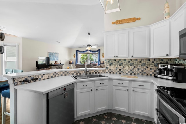 1644 Langley Dr, Longs, SC 29568 - kitchen featuring dishwasher, a peninsula, double oven range, white cabinets, and lofted ceiling
