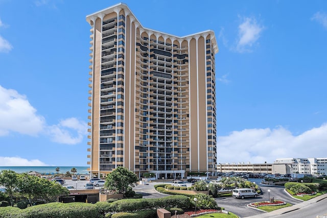 9650 Shore Dr Unit 209, Myrtle Beach, SC 29572 - view of apartment building / complex featuring uncovered parking and a water view