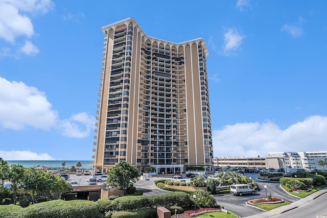 9650 Shore Dr Unit 209, Myrtle Beach, SC 29572 - view of apartment building / complex with uncovered parking and a water view