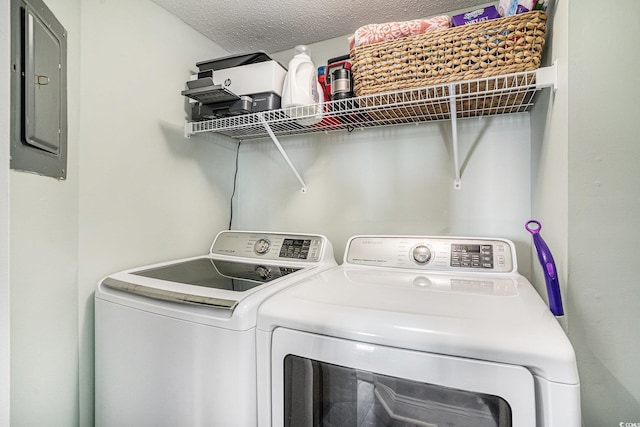 9650 Shore Dr Unit 209, Myrtle Beach, SC 29572 - washroom with electric panel, washing machine and clothes dryer, and a textured ceiling