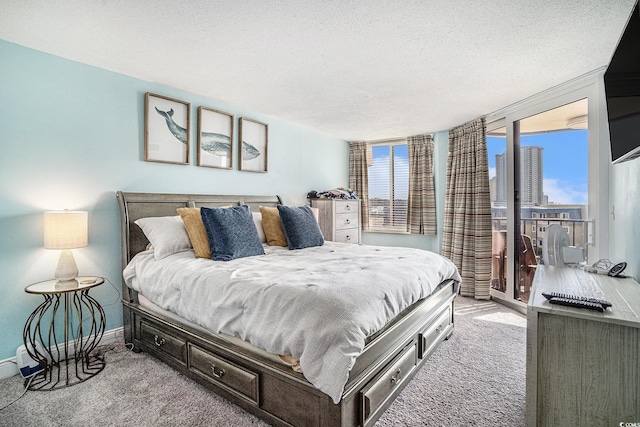 9650 Shore Dr Unit 209, Myrtle Beach, SC 29572 - bedroom featuring carpet flooring, multiple windows, a textured ceiling, and access to outside
