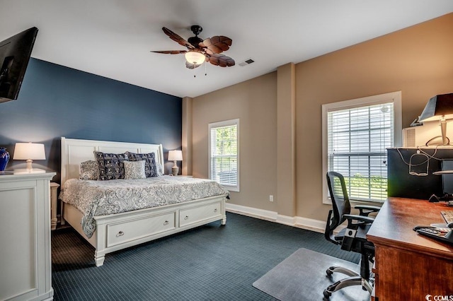 1733 24th Ave N, North Myrtle Beach, SC 29582 - bedroom with a desk, dark colored carpet, and a ceiling fan