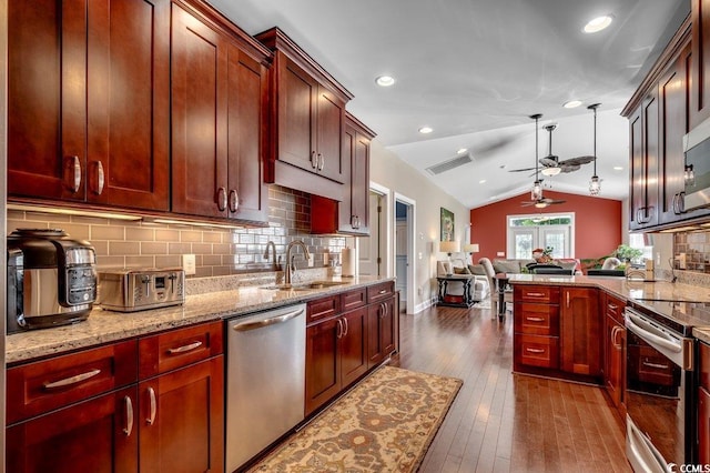 1733 24th Ave N, North Myrtle Beach, SC 29582 - kitchen featuring appliances with stainless steel finishes, vaulted ceiling, a ceiling fan, open floor plan, and dark wood-style floors