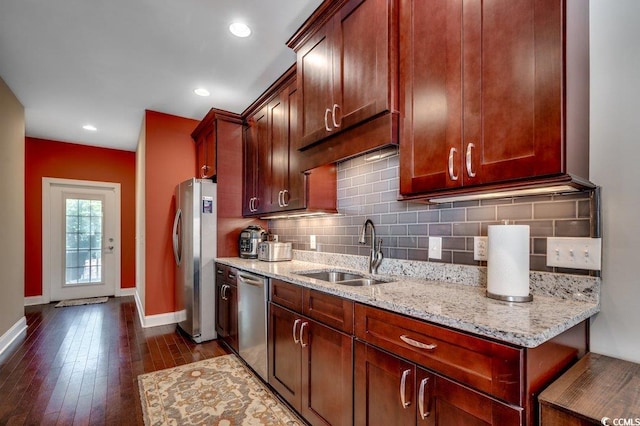 1733 24th Ave N, North Myrtle Beach, SC 29582 - kitchen featuring appliances with stainless steel finishes, decorative backsplash, light stone counters, dark wood-style floors, and recessed lighting