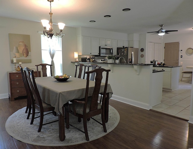 1307 Carolina Wren Ln, Murrells Inlet, SC 29576 - dining room with light wood-type flooring, a chandelier, and a ceiling fan