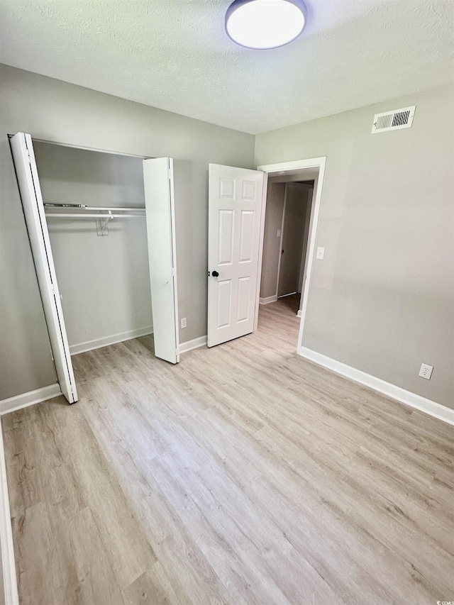 616 Mckinley Way, Conway, SC 29526 - unfurnished bedroom with wood finished floors, a closet, and a textured ceiling
