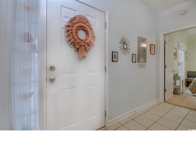 1058 Sea Mountain Hwy Unit 10-101, North Myrtle Beach, SC 29582 - entryway featuring light tile patterned floors, electric panel, and light colored carpet