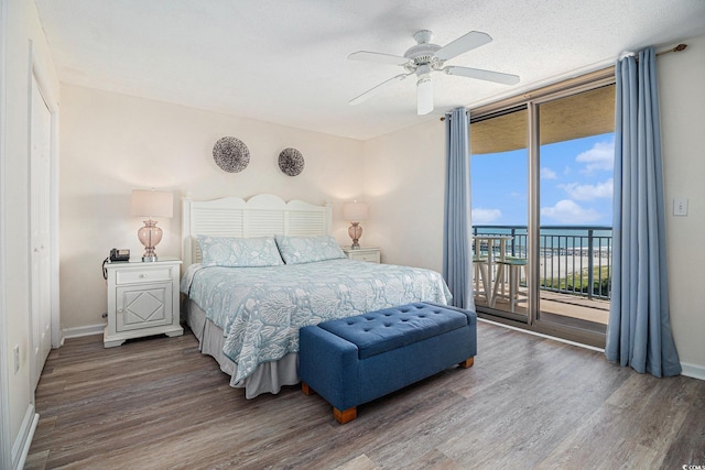 8560 Queensway Blvd Unit 706, Myrtle Beach, SC 29572 - bedroom featuring access to exterior, wood finished floors, floor to ceiling windows, a water view, and ceiling fan