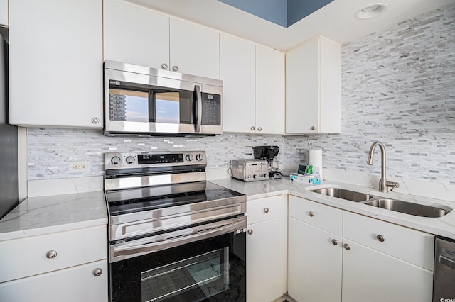 8560 Queensway Blvd Unit 706, Myrtle Beach, SC 29572 - kitchen with stainless steel appliances, backsplash, and white cabinetry