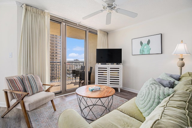 8560 Queensway Blvd Unit 706, Myrtle Beach, SC 29572 - living area featuring wood finished floors, ornamental molding, a ceiling fan, and expansive windows