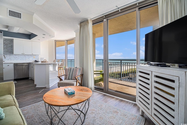 8560 Queensway Blvd Unit 706, Myrtle Beach, SC 29572 - living room featuring expansive windows, wood finished floors, a textured ceiling, ceiling fan, and crown molding
