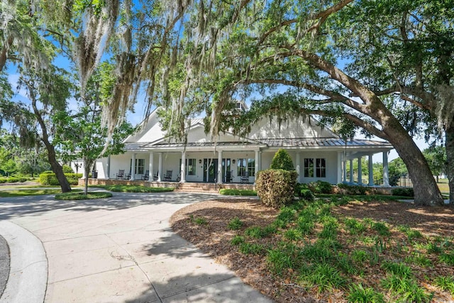 LOT142 Millbank Rd, Georgetown, SC 29440 - farmhouse inspired home featuring a porch, a standing seam roof, curved driveway, a metal roof, and stucco siding