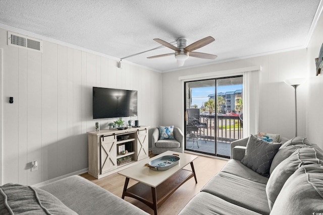 6001 N Ocean Blvd Unit 137, North Myrtle Beach, SC 29582 - living room with crown molding, light wood-type flooring, ceiling fan, and a textured ceiling