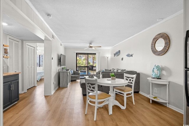 6001 N Ocean Blvd Unit 137, North Myrtle Beach, SC 29582 - dining space featuring crown molding, light wood-style floors, ceiling fan, and a textured ceiling