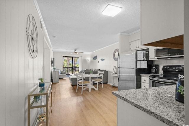 6001 N Ocean Blvd Unit 137, North Myrtle Beach, SC 29582 - kitchen with electric range, crown molding, freestanding refrigerator, light wood-type flooring, and white cabinetry