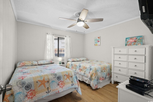 6001 N Ocean Blvd Unit 137, North Myrtle Beach, SC 29582 - bedroom featuring light wood-type flooring, ornamental molding, a textured ceiling, and a ceiling fan