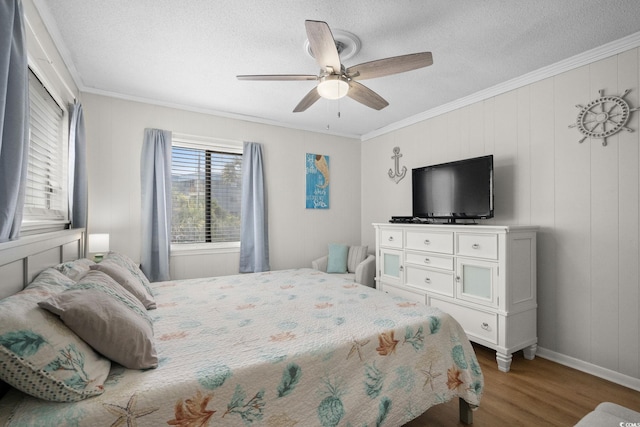 6001 N Ocean Blvd Unit 137, North Myrtle Beach, SC 29582 - bedroom featuring wood finished floors, crown molding, a textured ceiling, and a ceiling fan